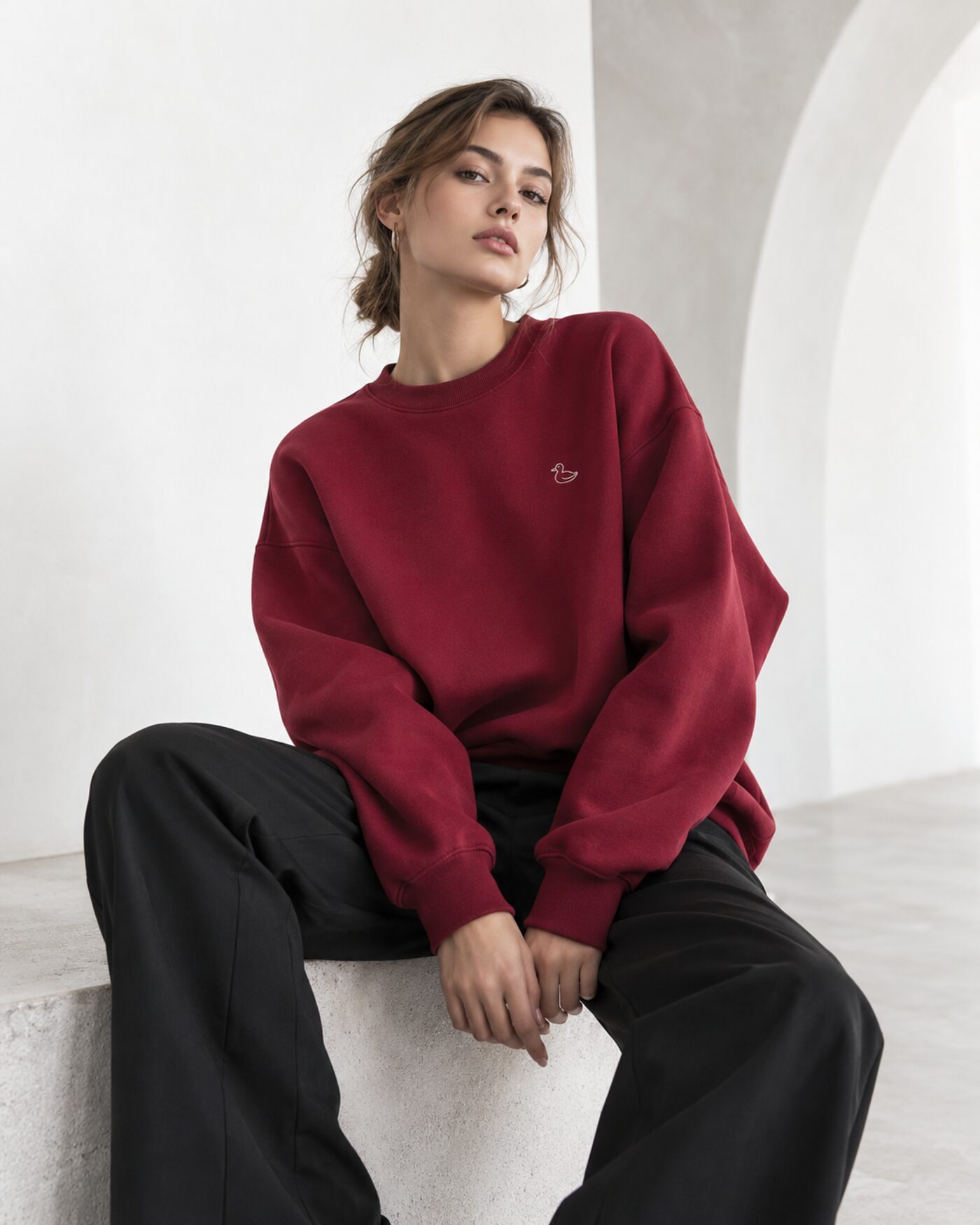 Model wearing the burgundy Mallard hoodie with the Duck Fashion duck logo.